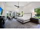 Serene main bedroom with neutral colors, an area rug, natural light, and doors to a balcony at 329 Bird Key Dr, Sarasota, FL 34236