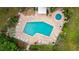 Aerial view of community pool, sun deck, and lush green landscaping at Wildewood Springs at 333 Springdale Dr # 333, Bradenton, FL 34210