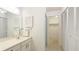 Clean bathroom showcasing a bright vanity and linen closet, next to a walk-in closet at 333 Springdale Dr # 333, Bradenton, FL 34210