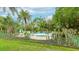 Community pool surrounded by lush tropical landscaping for a relaxing residential experience at 333 Springdale Dr # 333, Bradenton, FL 34210