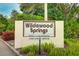Entrance sign for Wildewood Springs with well-maintained landscaping and clear signage at 333 Springdale Dr # 333, Bradenton, FL 34210