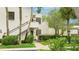 Two-story condo featuring lush landscaping, private entrances, and a textured facade at 333 Springdale Dr # 333, Bradenton, FL 34210