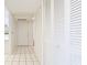 Bright hallway featuring white tile flooring and multiple storage closets at 333 Springdale Dr # 333, Bradenton, FL 34210