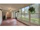 Enclosed lanai featuring hanging plants and views of the pool and garden at 333 Springdale Dr # 333, Bradenton, FL 34210