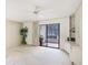 Bright living room featuring a ceiling fan, sliding glass doors, and custom built-in shelving at 333 Springdale Dr # 333, Bradenton, FL 34210