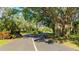 A charming street with mature trees and lush greenery provides a serene and inviting entrance to the neighborhood at 333 Springdale Dr # 333, Bradenton, FL 34210