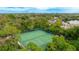 Aerial view of tennis courts surrounded by mature trees in a well-maintained community at 333 Springdale Dr # 333, Bradenton, FL 34210
