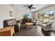 Inviting living room with hardwood floors, comfortable seating, a large window, and a ceiling fan at 3512 21St W Ave, Bradenton, FL 34205