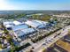 Aerial view of IMG Academy showcasing tennis courts, buildings, parking, and surrounding neighborhood at 3608 54Th W Dr # 102, Bradenton, FL 34210