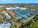 Lovely aerial view of property, tennis courts, and blue skies in a lush, landscaped community at 3608 54Th W Dr # 102, Bradenton, FL 34210