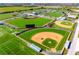 Aerial view showcases multiple well-maintained baseball fields and manicured lawns, offering ample space for sports and recreation at 3608 54Th W Dr # 102, Bradenton, FL 34210