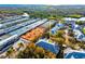 Aerial view of property, tennis courts, and lush landscaping offers a serene and active lifestyle at 3608 54Th W Dr # 102, Bradenton, FL 34210