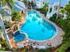 Aerial view of resort style pool, hot tub, and lounging area in lush landscaping at 3608 54Th W Dr # 102, Bradenton, FL 34210