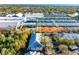 Aerial view showcases property near tennis courts, parking, and mature trees for convenient and outdoor living at 3608 54Th W Dr # 102, Bradenton, FL 34210