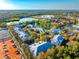 Stunning aerial view of the property near lake, tennis courts, and lush landscaping at 3608 54Th W Dr # 102, Bradenton, FL 34210