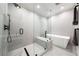 This bright bathroom includes a modern glass shower and a sleek, standalone bathtub at 3608 54Th W Dr # 102, Bradenton, FL 34210