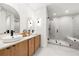 The bathroom features a glass shower, double sinks, and sleek modern finishes at 3608 54Th W Dr # 102, Bradenton, FL 34210