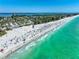 Overhead beach view featuring people enjoying the ocean, white sand, sun umbrellas, and coastal scenery perfect for leisure at 3608 54Th W Dr # 102, Bradenton, FL 34210
