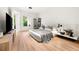 Bright bedroom boasts hardwood floors, a modern aesthetic, and natural light from the window at 3608 54Th W Dr # 102, Bradenton, FL 34210