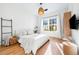 Bright bedroom with large window, wood floors, and cozy decor at 3608 54Th W Dr # 102, Bradenton, FL 34210