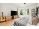 This bedroom has a TV, access to the patio, and an acoustic guitar at 3608 54Th W Dr # 102, Bradenton, FL 34210