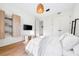 Sunlit bedroom featuring wood floors, modern lighting, and comfortable decor at 3608 54Th W Dr # 102, Bradenton, FL 34210