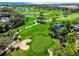 Aerial view features a lush golf course with manicured greens, water hazards, and tree-lined fairways for premier golfing at 3608 54Th W Dr # 102, Bradenton, FL 34210