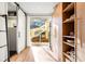 Bright hallway with wood floors, storage, and sliding glass door to outdoor stairs at 3608 54Th W Dr # 102, Bradenton, FL 34210
