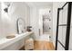 Hallway features contemporary lighting, minimalist decor, and access to the bathroom at 3608 54Th W Dr # 102, Bradenton, FL 34210