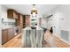 Bright, modern kitchen with a large island featuring stylish pendant lighting and wood cabinets at 3608 54Th W Dr # 102, Bradenton, FL 34210