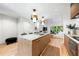 Bright kitchen boasts an island with marble counters, pendant lighting, and stainless steel appliances at 3608 54Th W Dr # 102, Bradenton, FL 34210