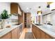 Gourmet kitchen featuring stainless appliances, an eat-in island, wood cabinets, and stone countertops at 3608 54Th W Dr # 102, Bradenton, FL 34210
