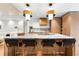 Bright, modern kitchen with a large island with seating and stylish pendant lighting at 3608 54Th W Dr # 102, Bradenton, FL 34210