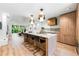 Open-concept kitchen with stainless appliances and a large island with seating and bright light at 3608 54Th W Dr # 102, Bradenton, FL 34210