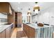 Open-concept kitchen featuring stainless appliances, wood cabinets, stone countertops, and an eat-in island at 3608 54Th W Dr # 102, Bradenton, FL 34210