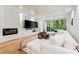 Bright living room features a large white sectional, coffered ceilings, fireplace and doors to the outdoors at 3608 54Th W Dr # 102, Bradenton, FL 34210