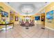 Bright lobby with seating area, tiled floors, high ceilings, chandelier, and art create a welcoming entrance at 3608 54Th W Dr # 102, Bradenton, FL 34210