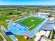 Aerial view of IMG Academy showcasing baseball diamonds, track and field, and pristine football field at 3608 54Th W Dr # 102, Bradenton, FL 34210