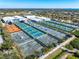 Aerial of tennis courts at IMG Academy shows various court colors and a well-maintained complex surrounded by greenery at 3608 54Th W Dr # 102, Bradenton, FL 34210
