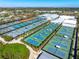 Aerial view of tennis courts at IMG Academy, with multiple colored courts and a lush, green background at 3608 54Th W Dr # 102, Bradenton, FL 34210