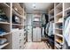 Well-organized walk-in closet with custom shelves and drawers provides ample storage at 3608 54Th W Dr # 102, Bradenton, FL 34210