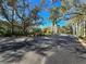 A street runs through the community, lined with trees and landscaping, with glimpses of the buildings at 4152 Central Sarasota Pkwy # 724, Sarasota, FL 34238
