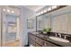 Bathroom featuring double sinks, a walk-in shower and plenty of storage space at 4234 Gulf Of Mexico Dr # Q2, Longboat Key, FL 34228