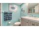 This bathroom features turquoise-painted walls, updated vanity and fixtures at 4234 Gulf Of Mexico Dr # Q2, Longboat Key, FL 34228