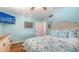 This bedroom features aqua-painted walls, hardwood flooring, and a large bed at 4234 Gulf Of Mexico Dr # Q2, Longboat Key, FL 34228