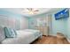 This bedroom features aqua-painted walls, hardwood flooring, and a ceiling fan at 4234 Gulf Of Mexico Dr # Q2, Longboat Key, FL 34228