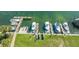 Aerial view of boat docks with multiple boats, kayaks, and green grass at 4234 Gulf Of Mexico Dr # Q2, Longboat Key, FL 34228