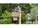 A charming community sign made of wood with beautiful landscaping at 4234 Gulf Of Mexico Dr # Q2, Longboat Key, FL 34228