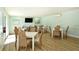Well-lit dining area with multiple tables, chairs, and relaxing ambiance at 4234 Gulf Of Mexico Dr # Q2, Longboat Key, FL 34228