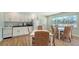 Open kitchen with white cabinets, dining area, and modern appliances at 4234 Gulf Of Mexico Dr # Q2, Longboat Key, FL 34228